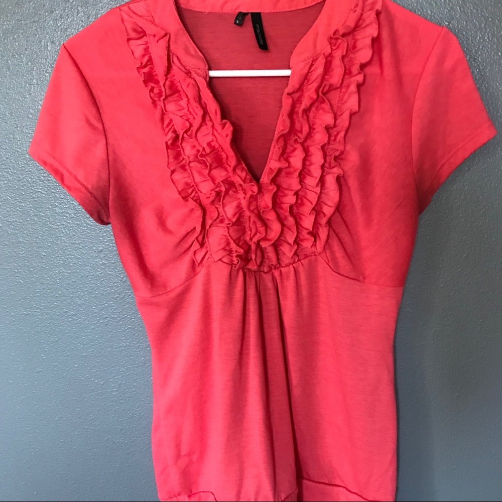 Coral dressy top with ruffle front.
